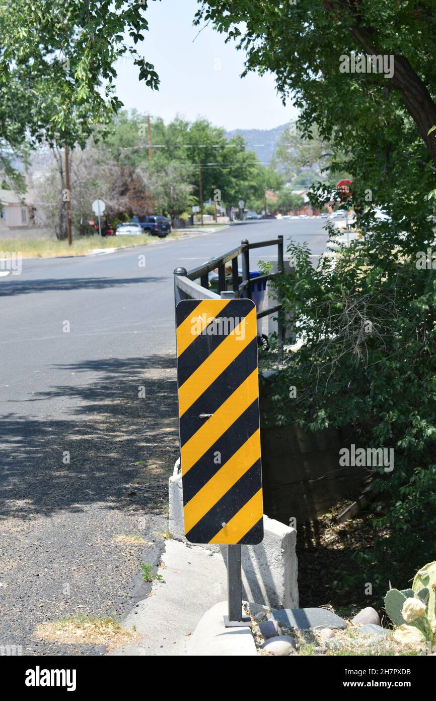 A black and yellow striped sign marks a bridge Stock Photo Alamy