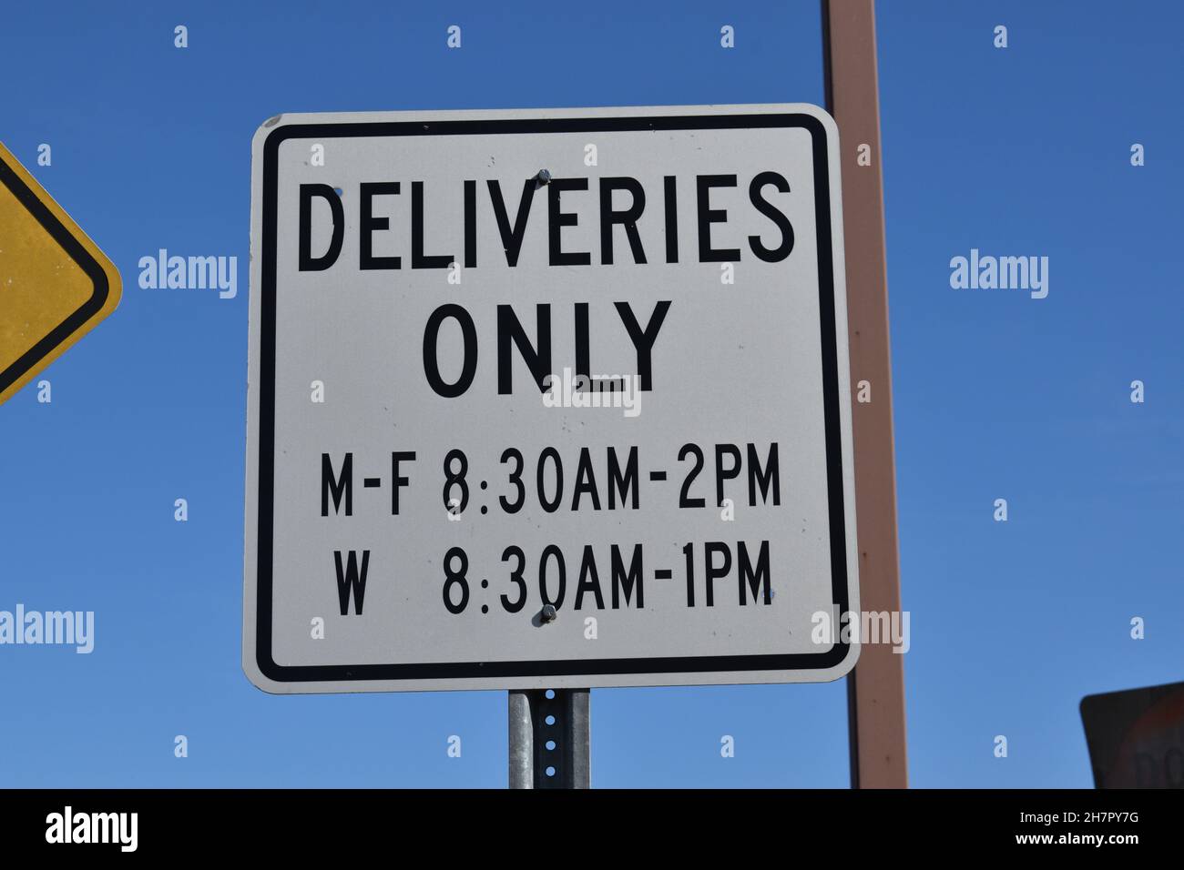 A sign says deliveries only. Stock Photo