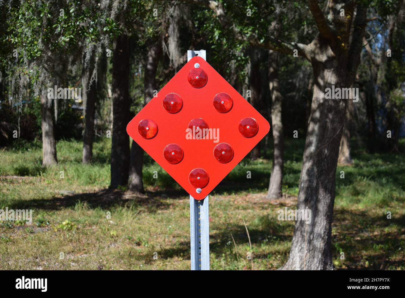 A bright red sign with red reflective lenses Stock Photo - Alamy