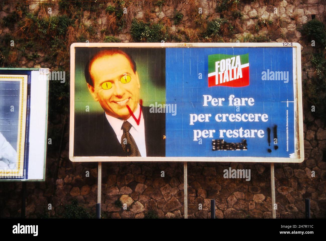 Silvio Berlusconi 1995 political campaign. Mega election poster revised and modified by an unknown oppositor street artist. Berlusconi as one of the Visitors. Stock Photo
