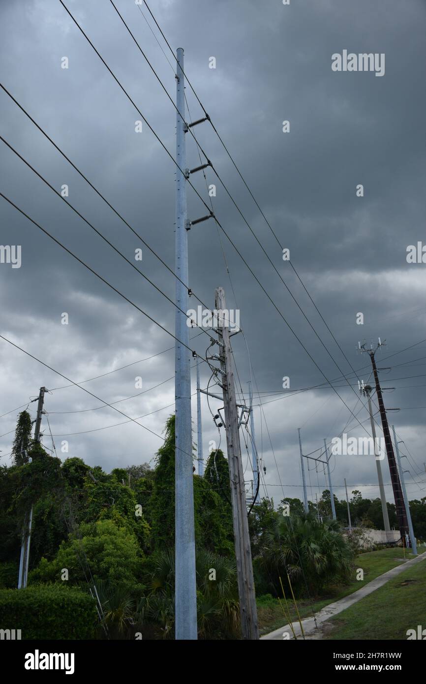 The landscape is covered by utility poles and electric wires. Stock Photo