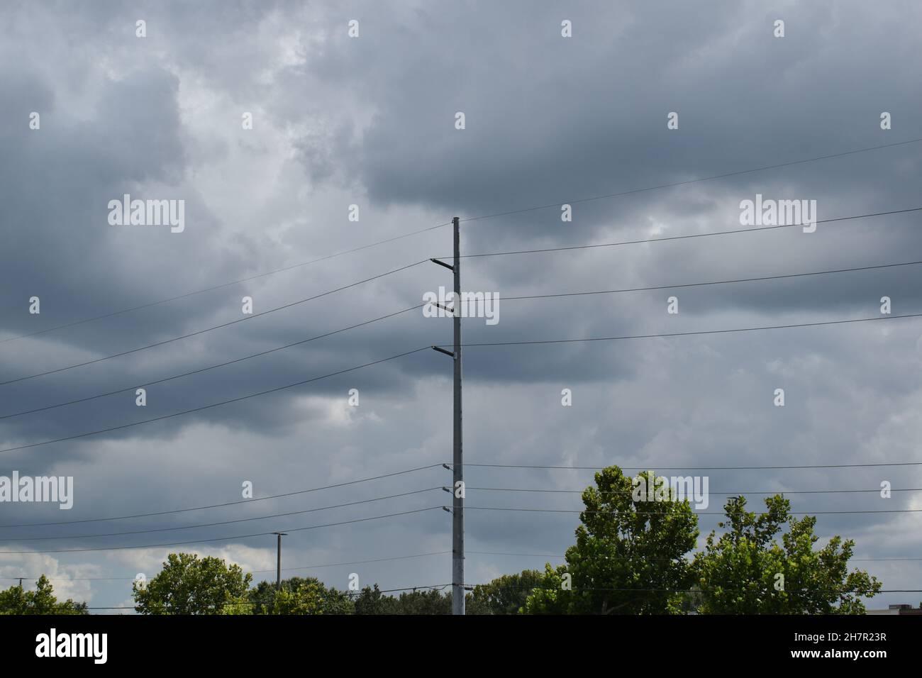 High voltage electric power lines span a stormy gray sky Stock Photo ...