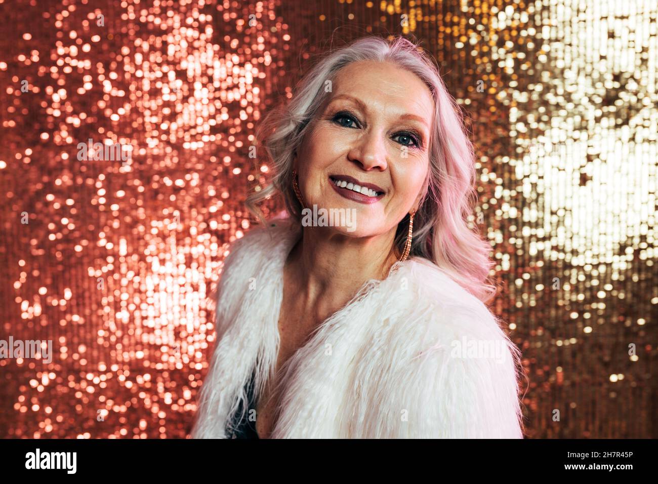 Portrait of a cheerful senior woman posing in studio and looking at camera Stock Photo