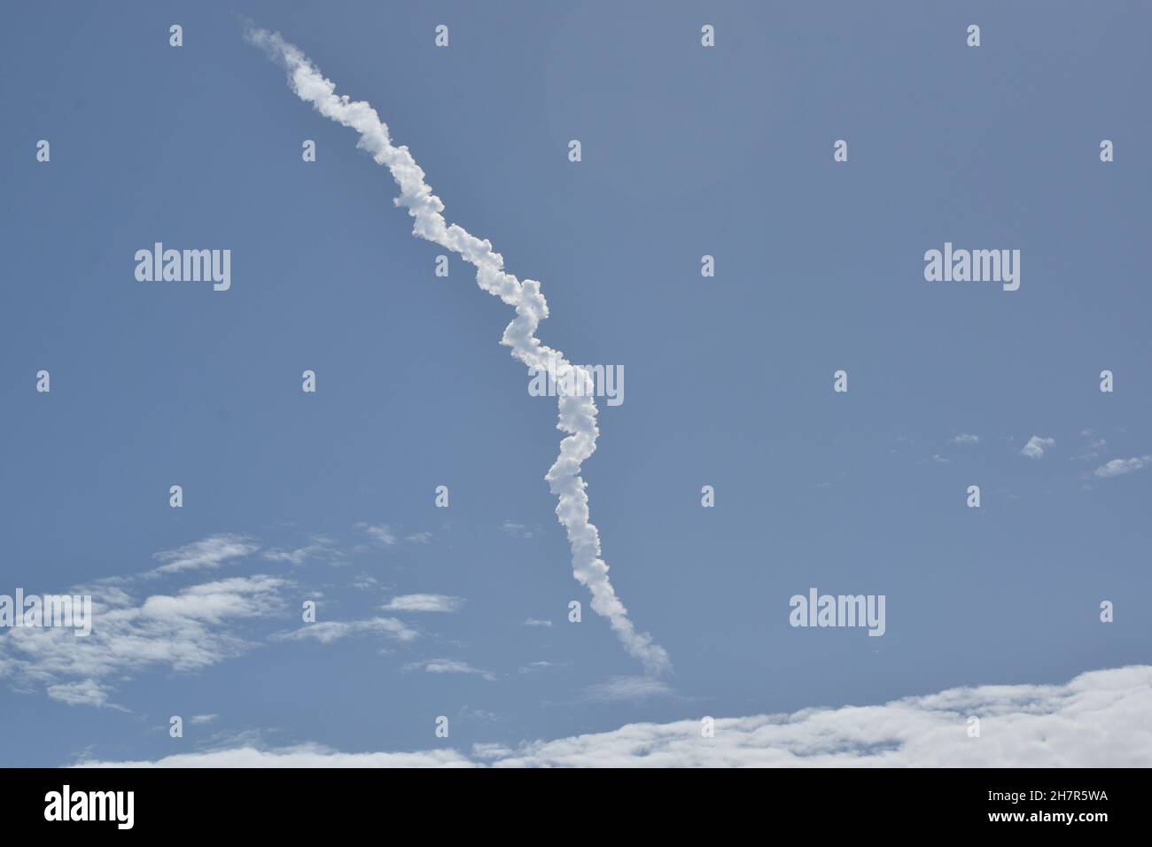 The long squiggly contrail remains after a successful launch of SpaceX's Falcon 9 rocket. Stock Photo