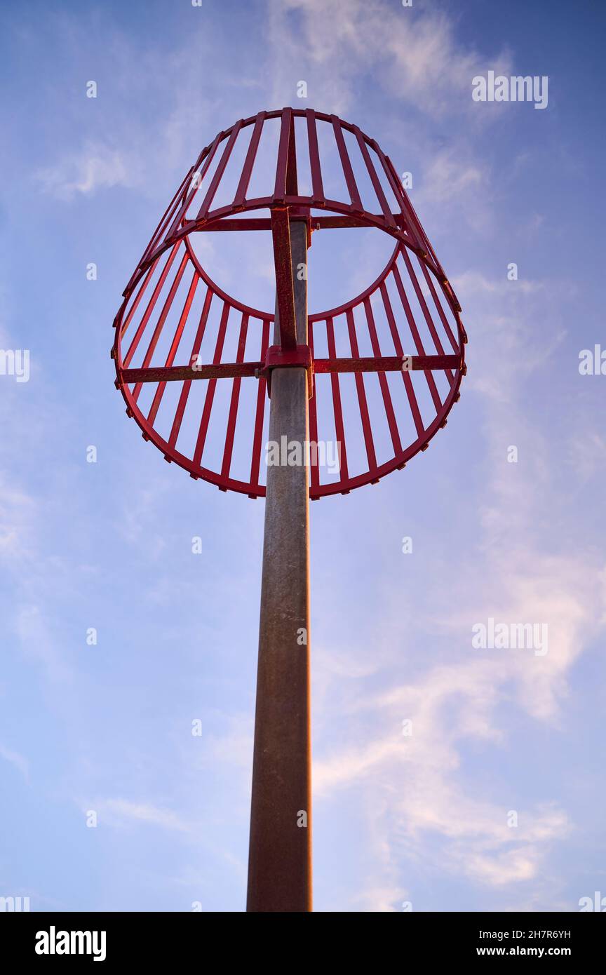 Red warning marker against sky Stock Photo