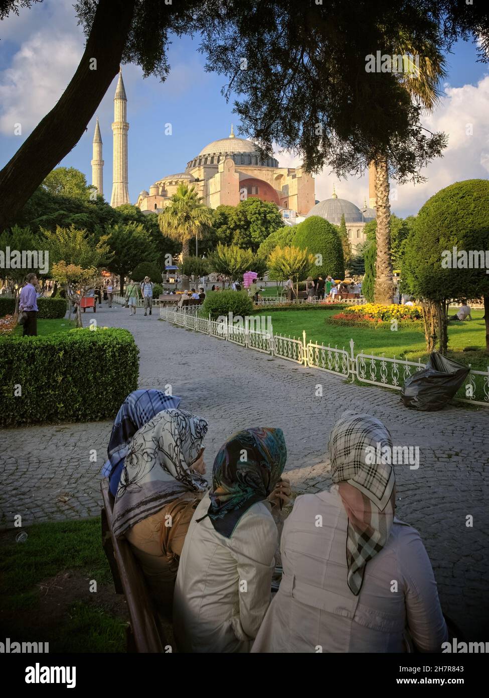 street scene of Istanbul women with headscarfs are sitting on a bench of Hagia Sophia Mosque's public garden Stock Photo