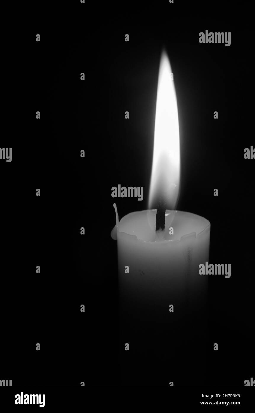 Grayscale shot of a burning candle Stock Photo Alamy