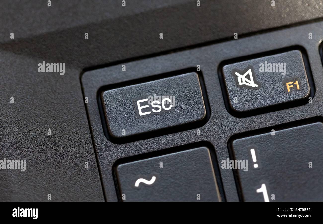 Laptop computer keyboard Esc, escape key macro detail, top view, object extreme closeup, from above, nobody. Stop, no, quit, cancel, abort key, escape Stock Photo