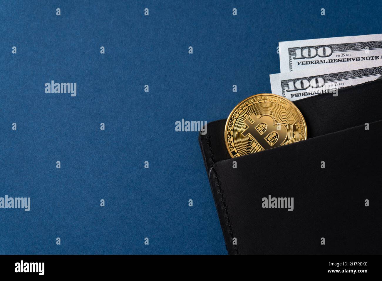Money and cryptocurrency in a men's wallet. Virtual money concept in reality on blue background. Copy space Stock Photo