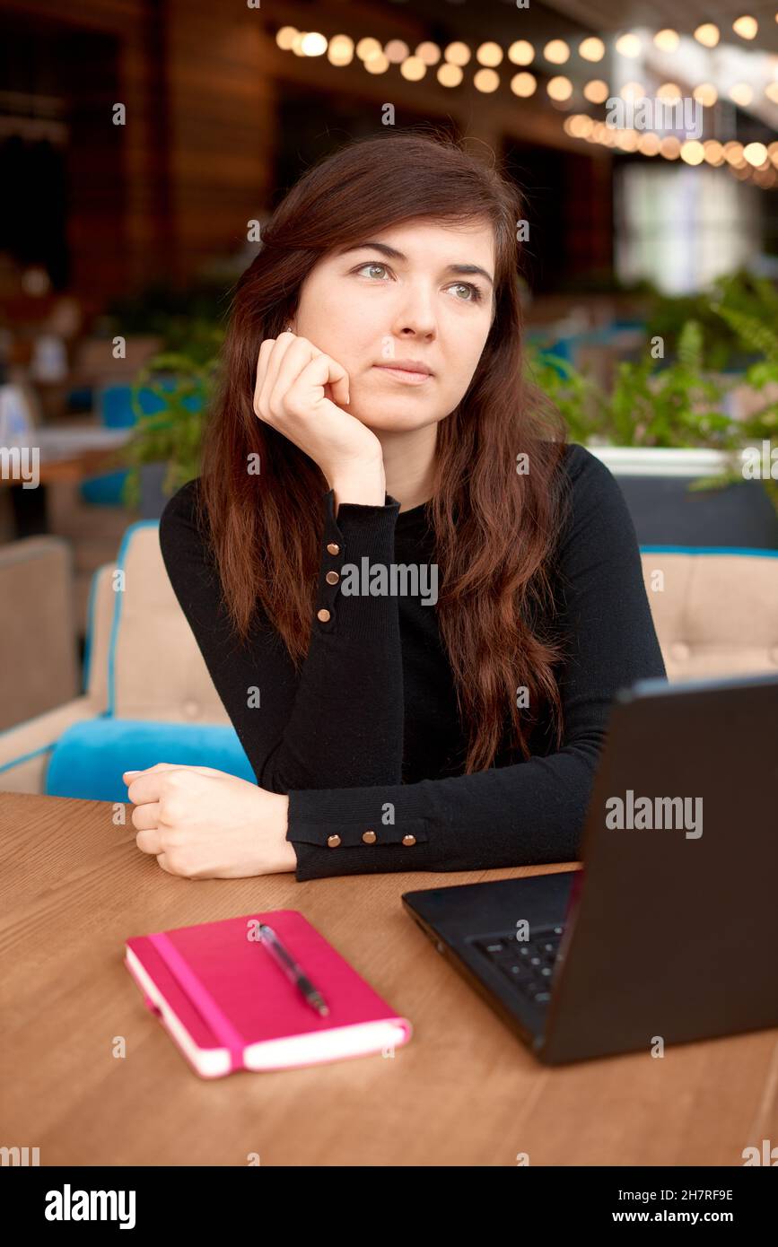 buy nothing day concept. woman use laptop and think about vacation. dream about trip. Stock Photo