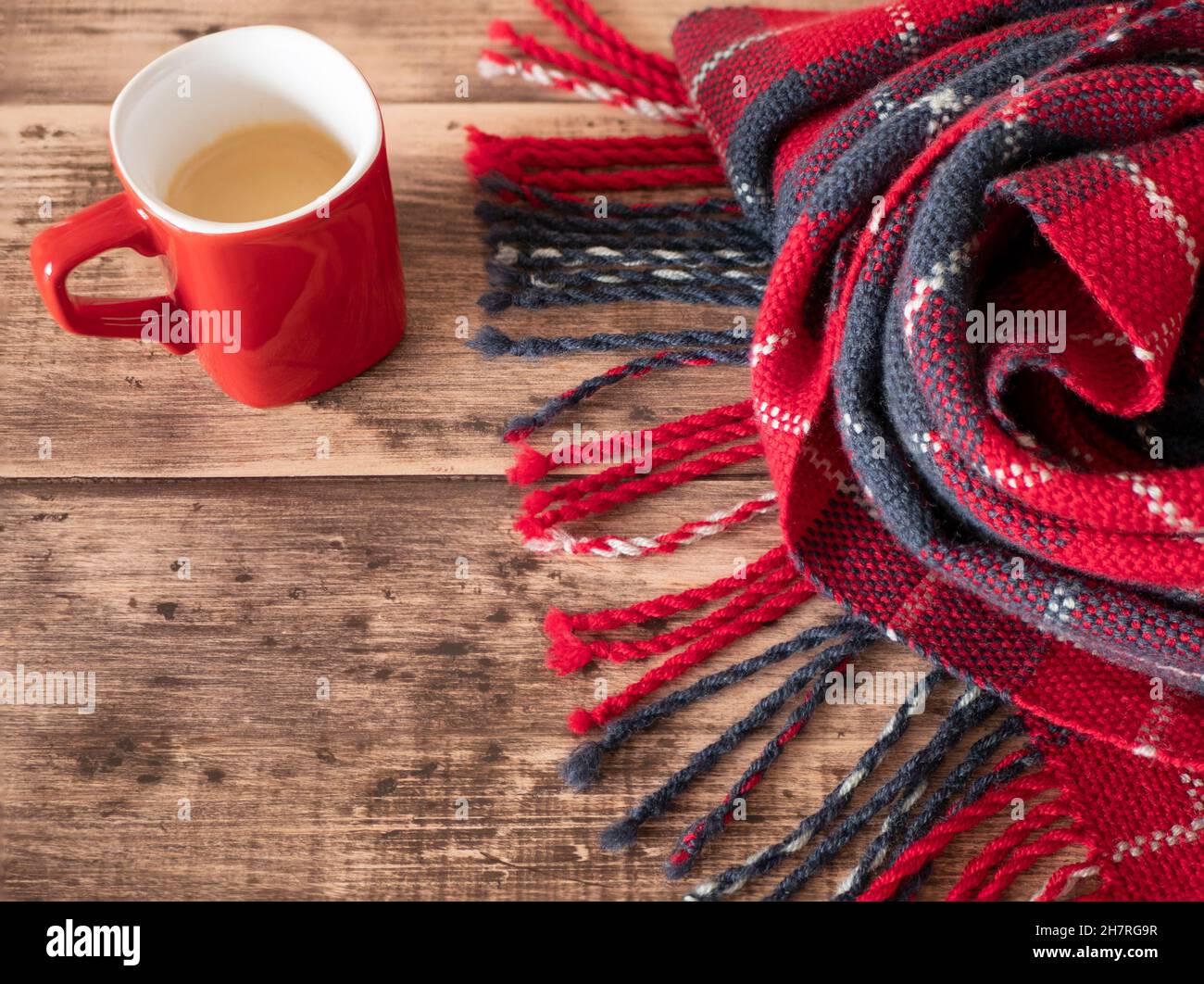 Warm tartan rug and a cup of coffee. Concept of cozy and warm atmosphere, copy space Stock Photo
