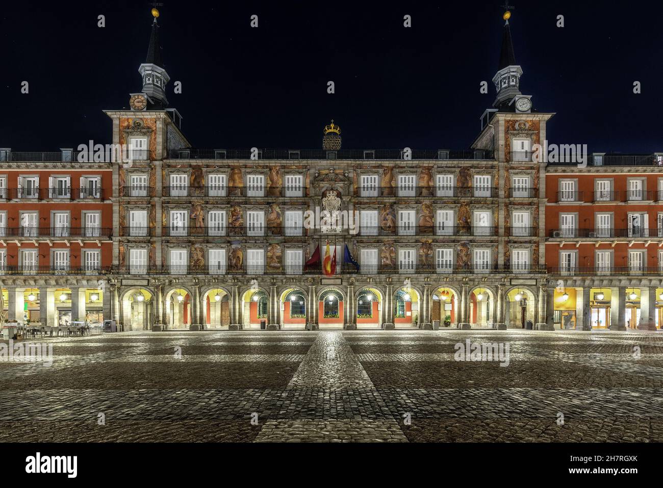 Central square of the city of Madrid with illuminated arcades and cobblestone floor. Stock Photo