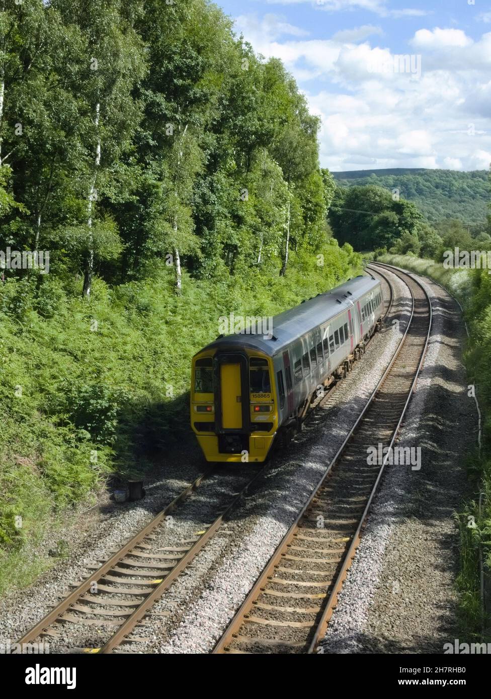 Class 158 passenger train, approaching Grindleford, on the Hope Valley line, Derbyshire, Peak district England Stock Photo