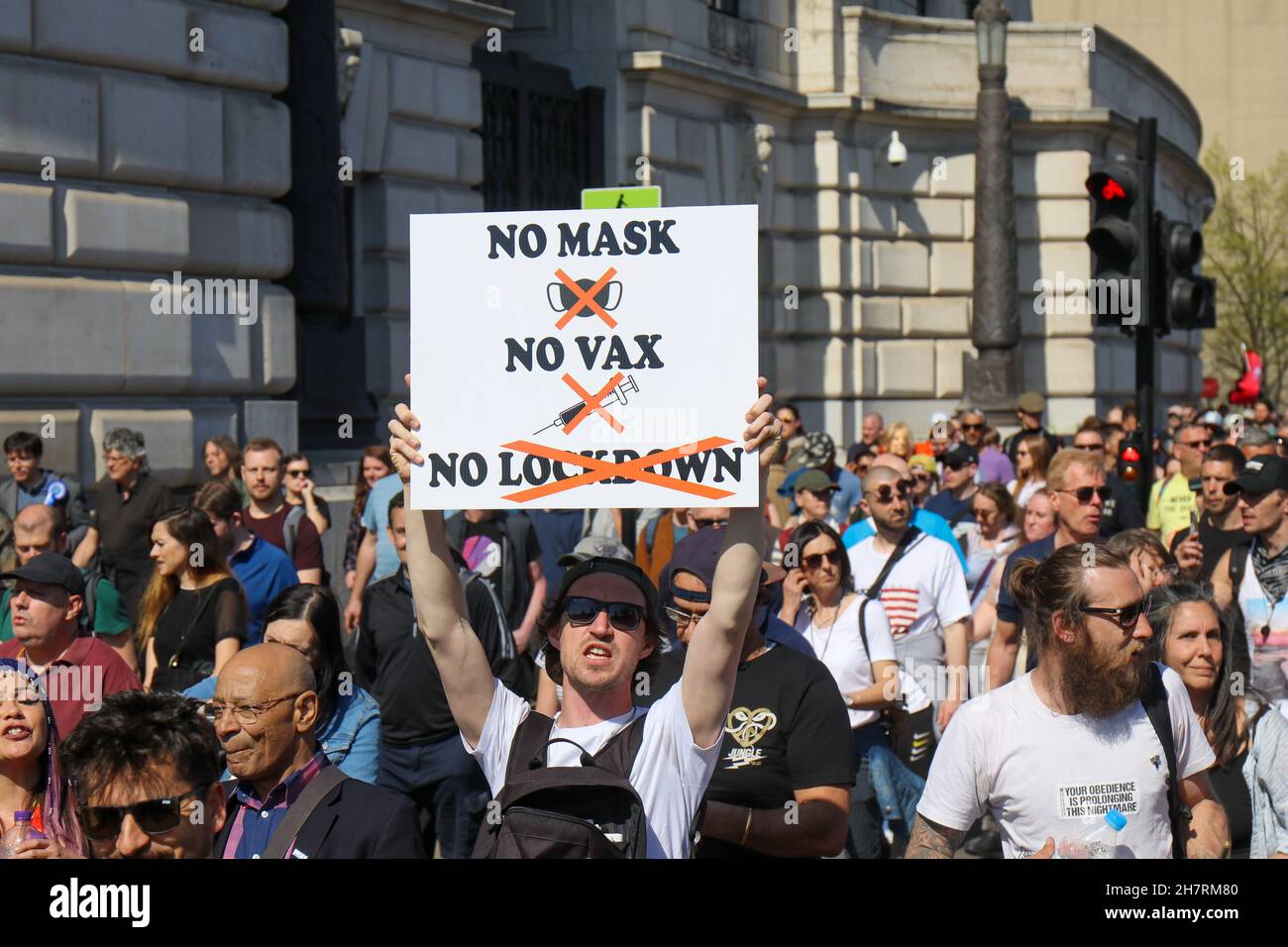 Man Holds Sign with "No Mask, No Vax, No Lockdown" Stock Photo