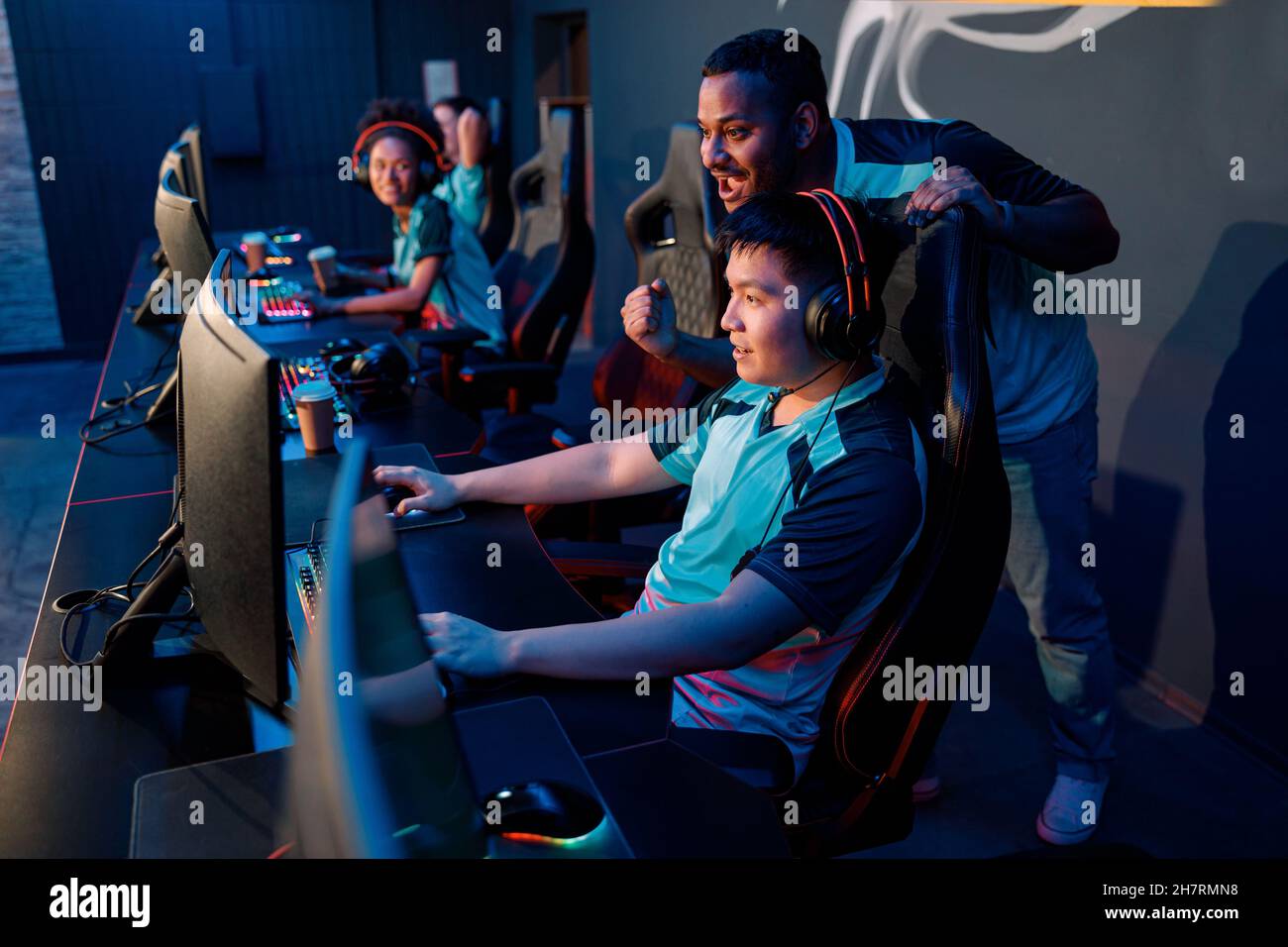 Professional esports players playing online games in internet cafe Stock Photo