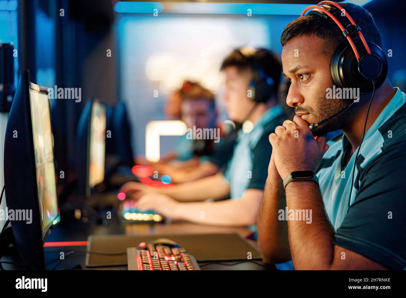 Young professional esports players playing online games in internet cafe Stock Photo