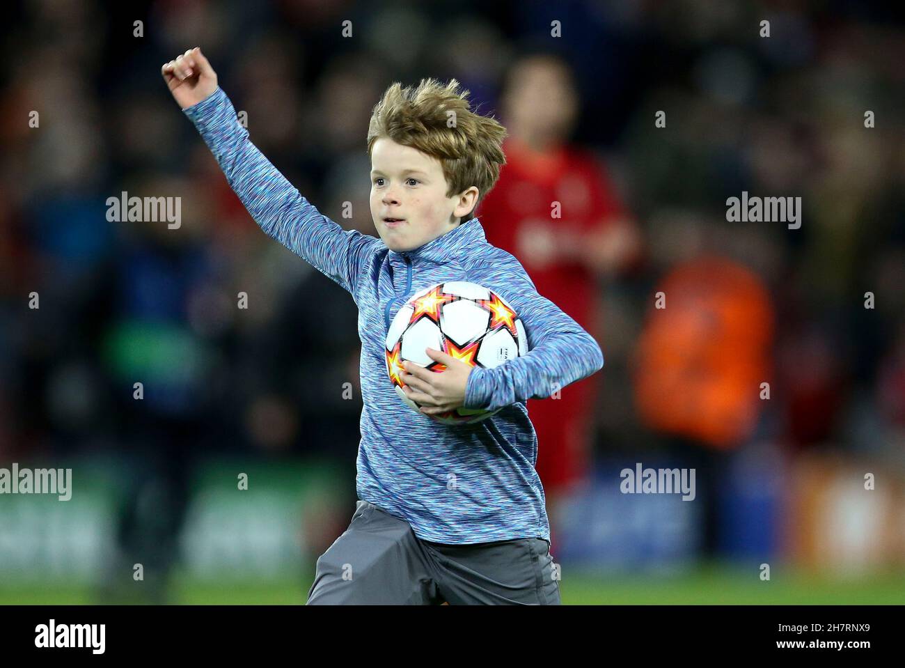 Liverpool, UK. 24th Nov, 2021. A youngster runs onto the pitch and grabs the match ball. UEFA Champions league, group B match, Liverpool v Porto at Anfield Stadium in Liverpool on Wednesday 24th November 2021. this image may only be used for Editorial purposes. Editorial use only, license required for commercial use. No use in betting, games or a single club/league/player publications. pic by Chris Stading/Andrew Orchard sports photography/Alamy Live news Credit: Andrew Orchard sports photography/Alamy Live News Stock Photo