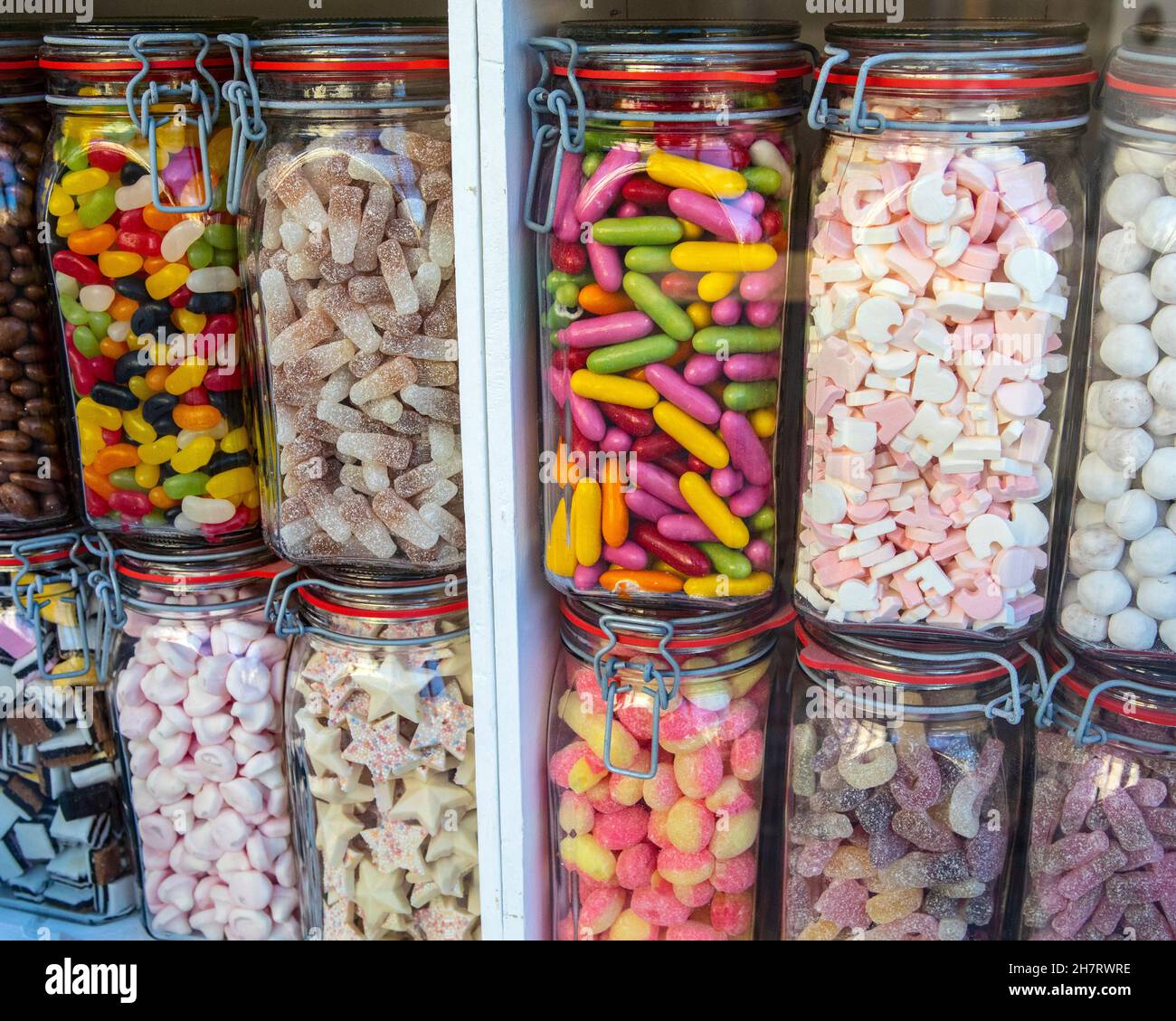 Close-up of jars of sweets in a shop window. Stock Photo