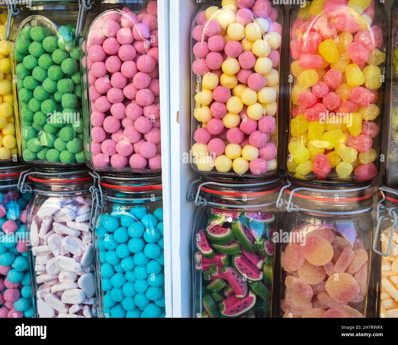 Close-up of jars of sweets in a shop window. Stock Photo