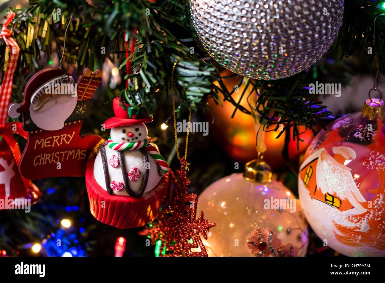 Christmas tree with shiny toys, lights, and decorations in winter Stock ...