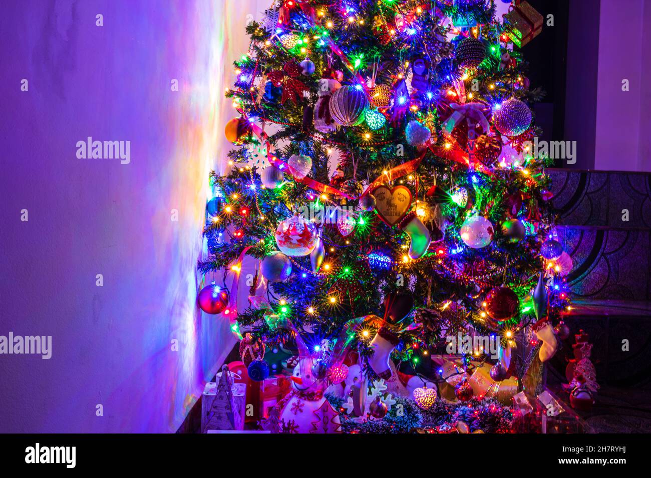 Christmas tree with shiny toys, lights, and decorations in winter Stock ...