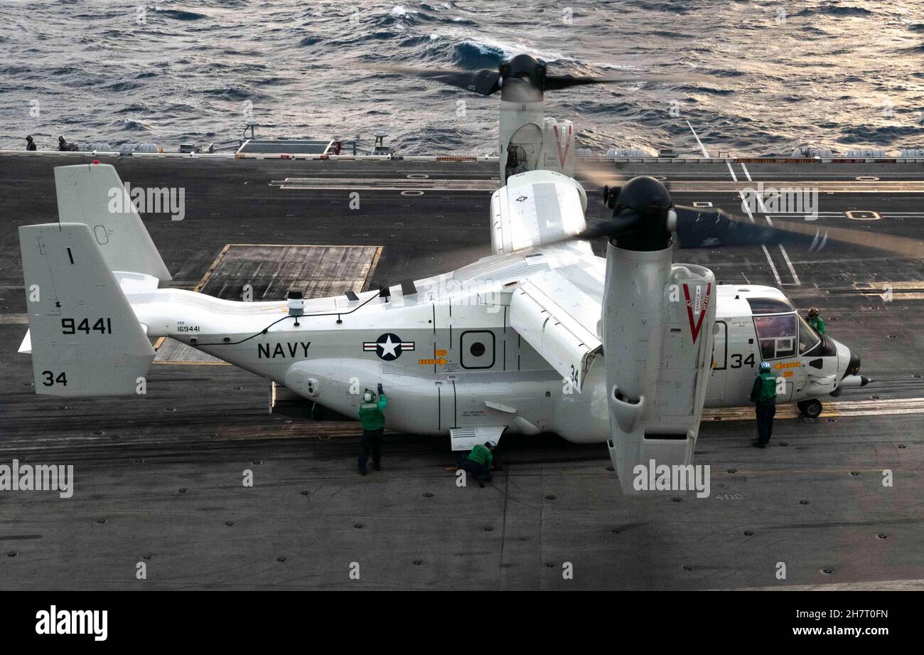 211124-N-BC658-1079 PHILLIPINE SEA (Nov. 24, 2021) A CMV-22B Osprey, assigned to the “Titans” of Fleet Logistics Multi-Mission Squadron (VRM) 30 taxis on the flight deck of Nimitz-class aircraft carrier USS Carl Vinson (CVN 70) while carrying Master Chief Petty Officer of the Navy (MCPON) Russell Smith. MCPON Smith visited multiple commands across Japan to visit with Sailors to hear about the challenges they face while serving in the 7th Fleet area of responsibility. (U.S. Navy photo by Mass Communication Specialist 2nd Class Russell Lindsey) Stock Photo