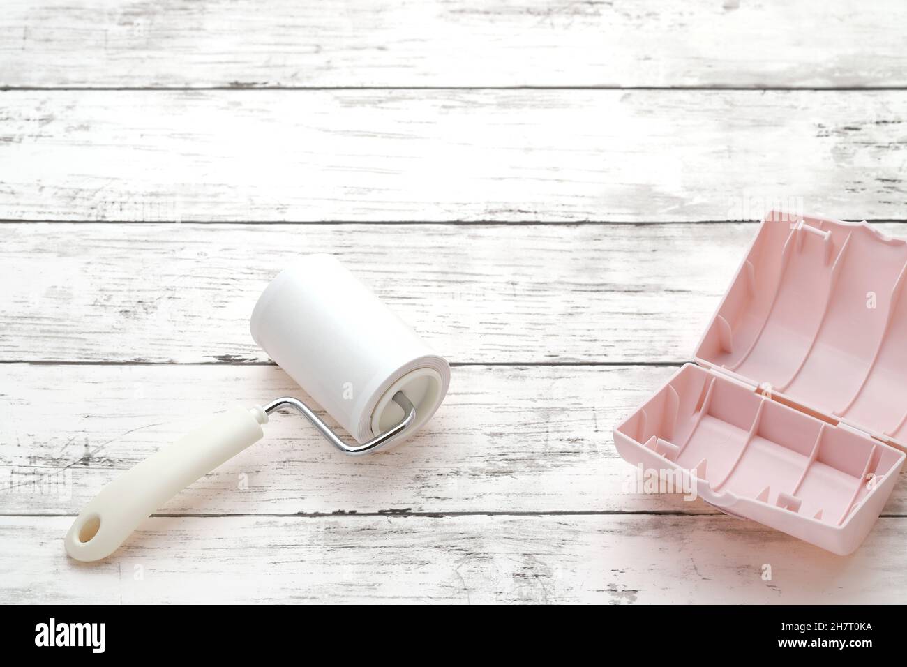 sticky roller cleaning, housework and housekeeping concept Stock Photo