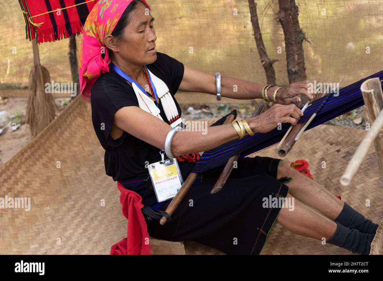 A Nagamese women is weaving thread by hand in a village in Nagaland India on 2 December 2016 Stock Photo