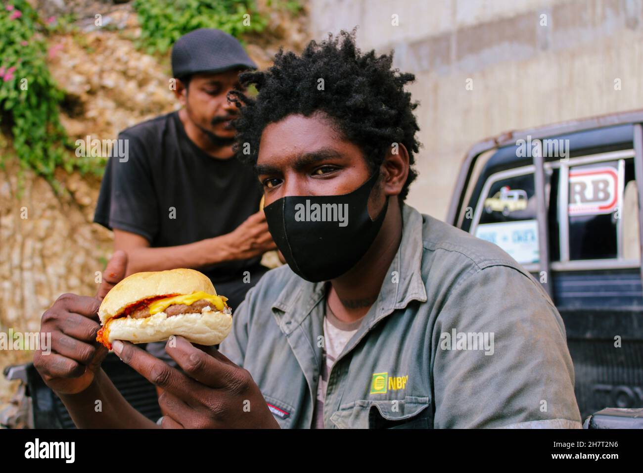 A Papua New Guinea foodie about to eat a burger in Port Moresby in November 2021 Stock Photo