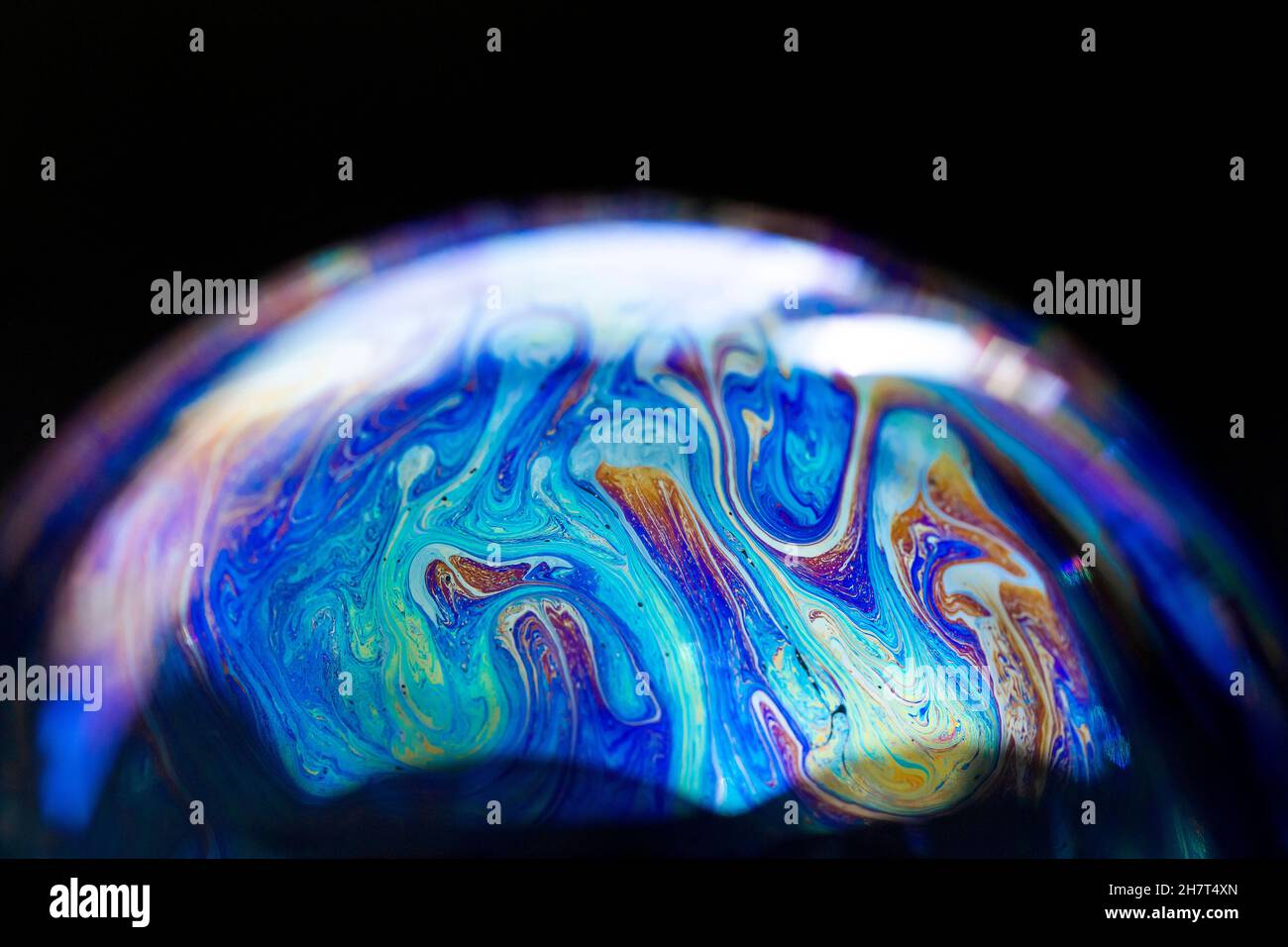 Abstract pattern, multicolored chaotic texture inside of the soap bubble, closeup Stock Photo