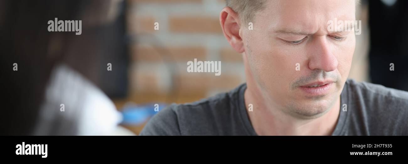 Male photographer is looking at camera screen with concentration Stock Photo