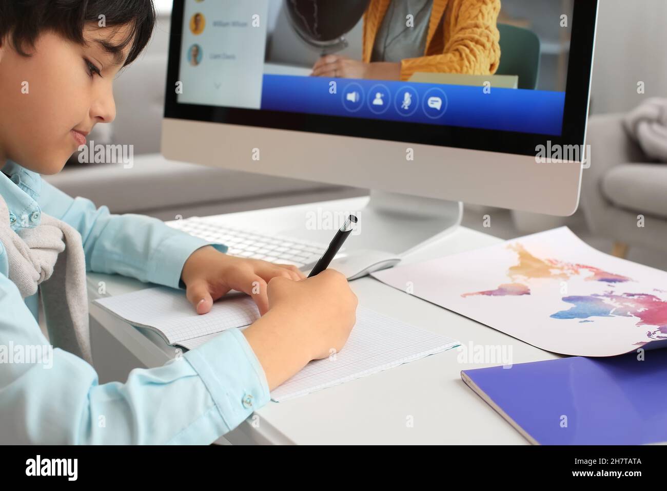 Little boy studying Geography online at home Stock Photo