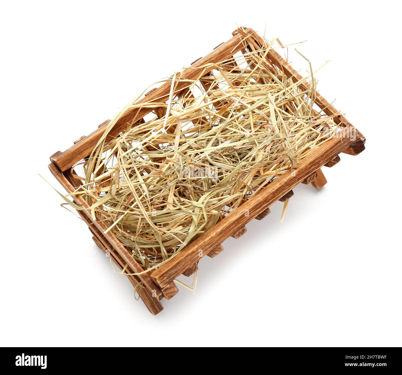 Wooden manger with hay on white background Stock Photo - Alamy
