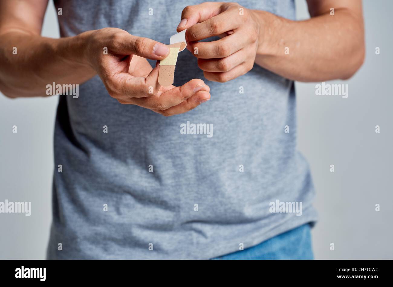 man with a plaster on his finger injury treatment medicine Stock Photo