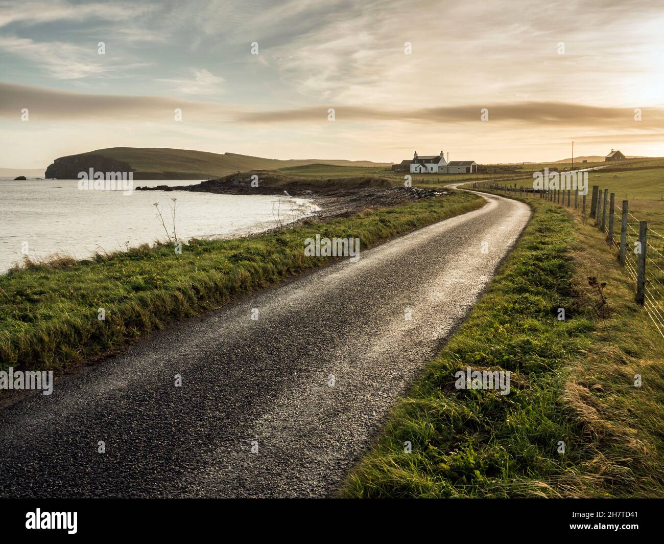 View east at dawn along road from Melby Pier, near Sandness, Shetland Stock Photo