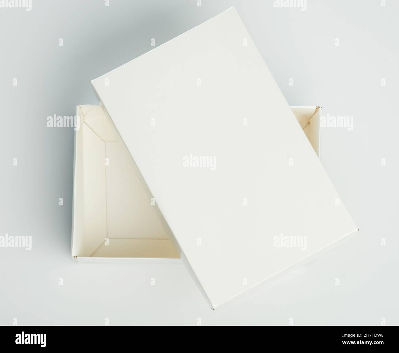 White gift paper box with cover isolated on studio background Stock Photo