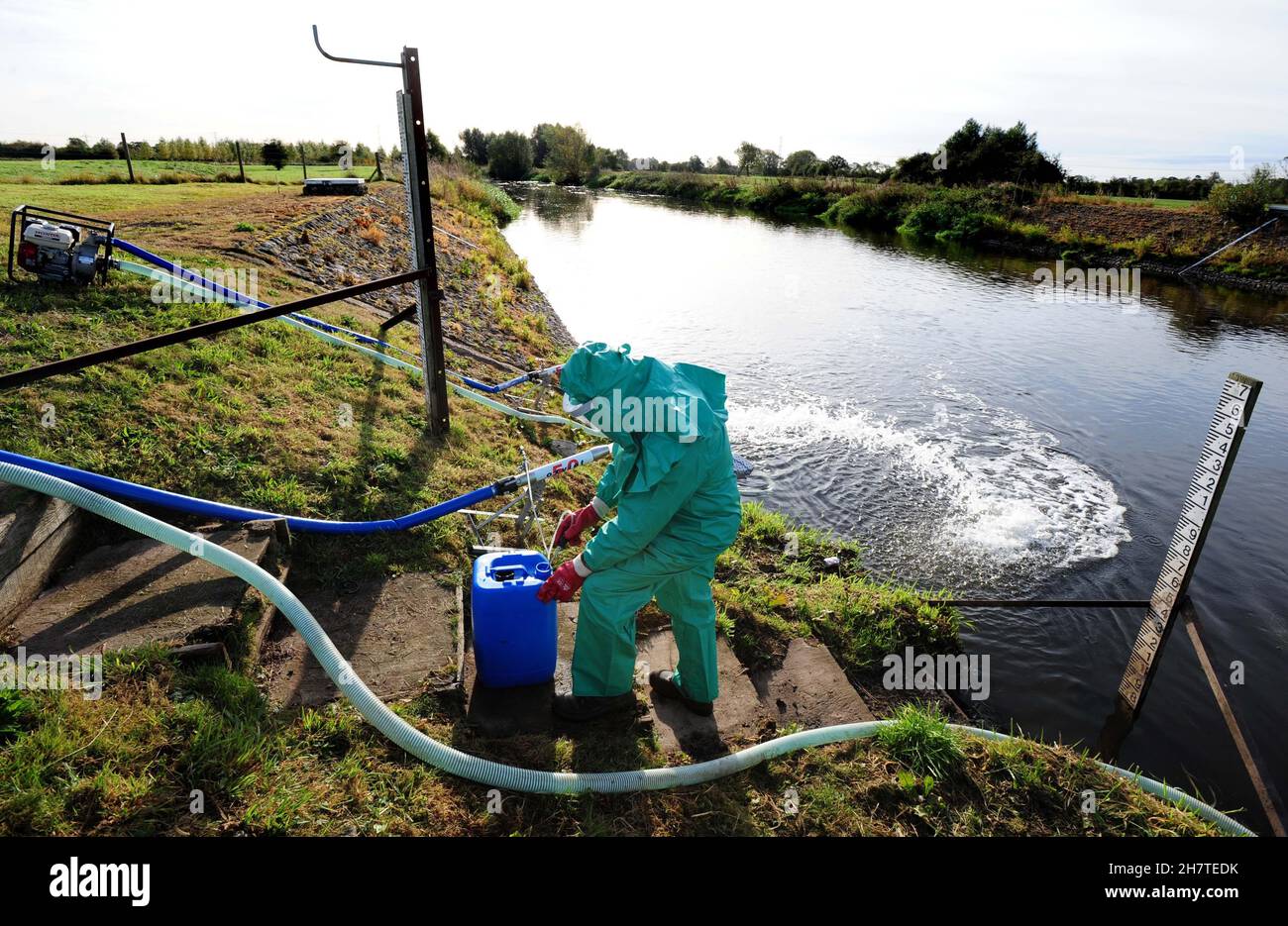 File photo dated 07/10/09 of an Environment Agency worker treating the River Trent at Yoxall, Staffordshire, after it was contaminated with untreated sewage and cyanide. Water companies in England and Wales issued more than 5,500 alerts of sewage being discharged into coastal waters in the last year, a report says. Stock Photo