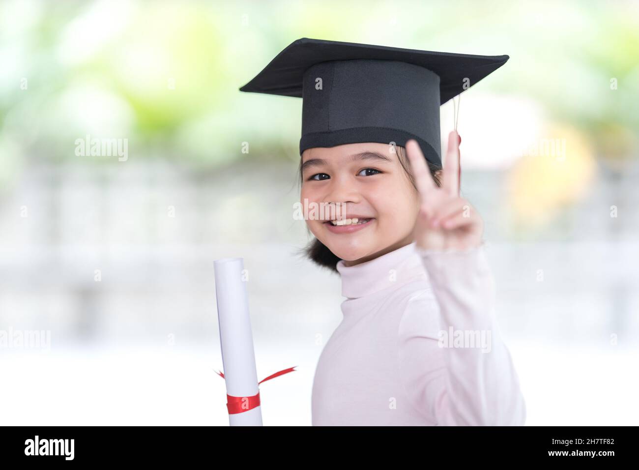 Happy Southeast Asian Schoolgirl With A Certificate Celebrating Graduation In Thailand Stock 