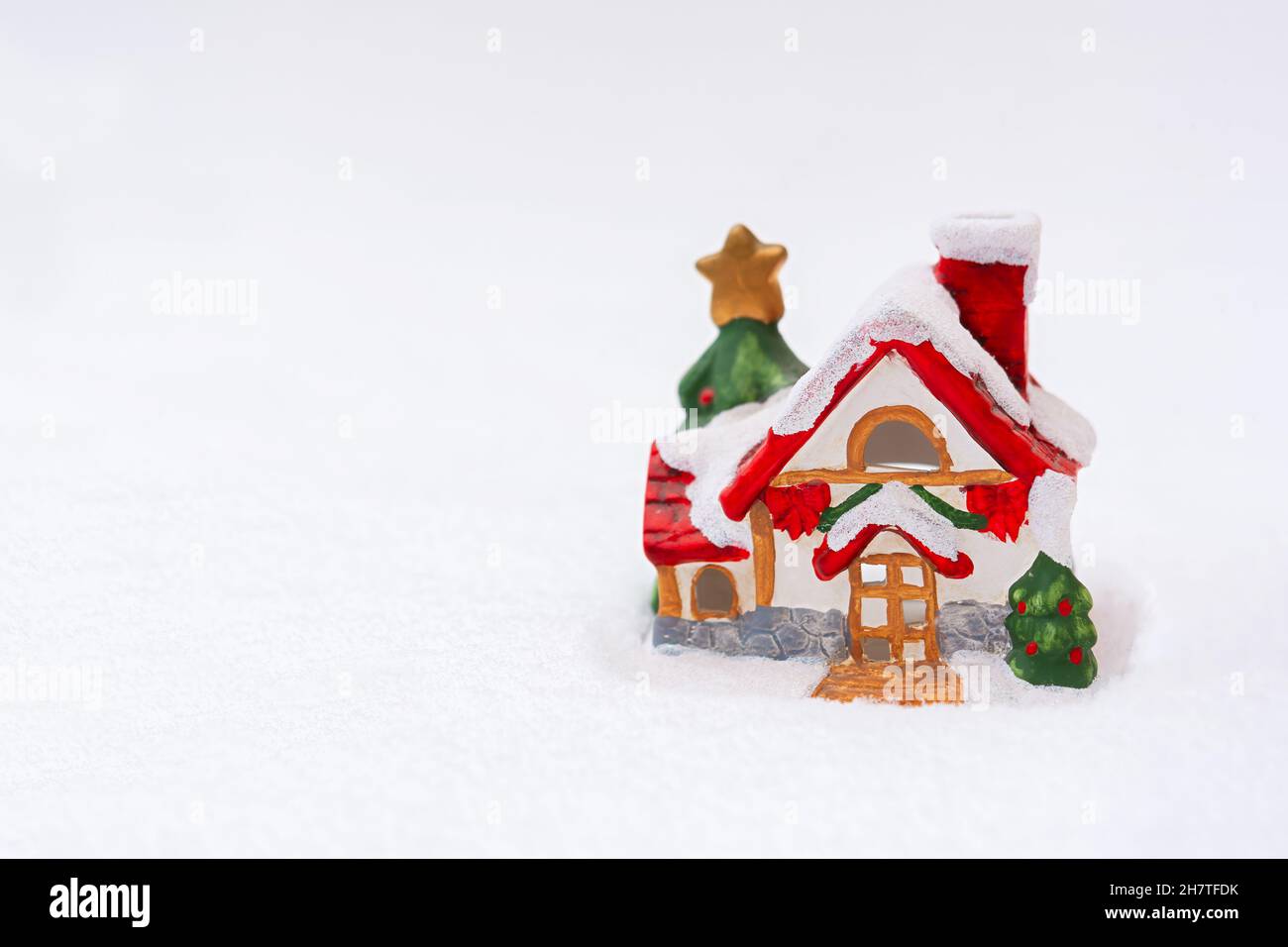 Christmas house snow. Christmas colorful horizontal postcard copy space. The concept of a holiday, a festive mood. A fabulous atmosphere, a toy clay r Stock Photo