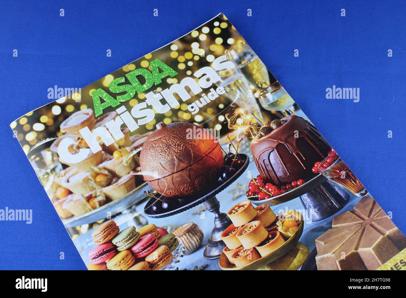 Asda Christmas food guide, Asda Christmas catalogue isolated on a blue background. Asda instore Christmas food guide magazine Stock Photo
