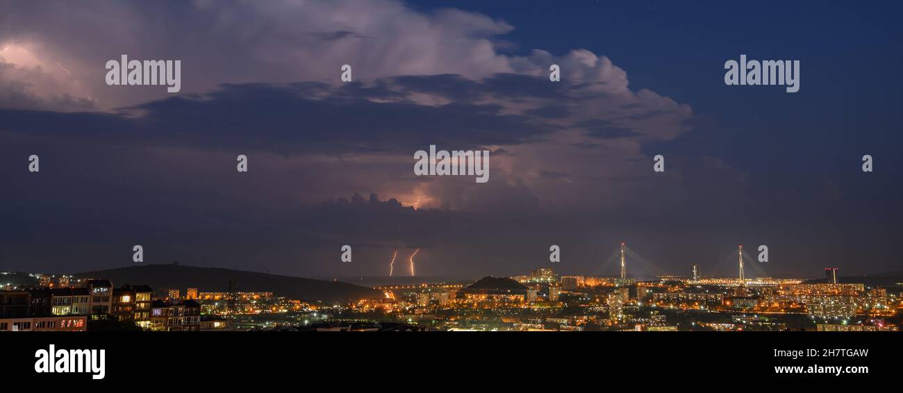 Lightning storm at night over city Stock Photo - Alamy