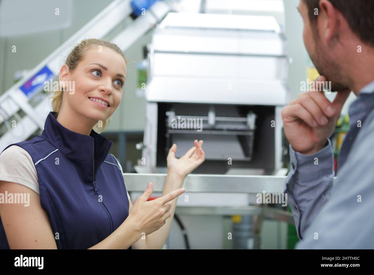 factory worker showing how the machine works Stock Photo Alamy