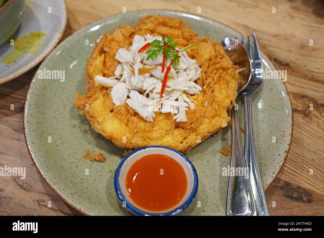 Deep fried crab meat omelet served with chili sauce Stock Photo Alamy