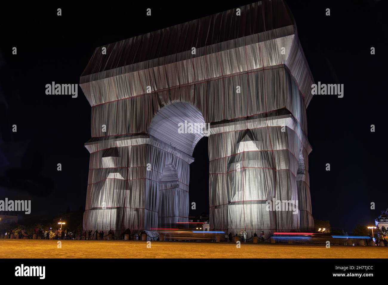 Paris, France-September 2021; Low angle view by night of wrapped and illiuminatied Arc de Triomphe art installation by Christo with Place Charles de G Stock Photo