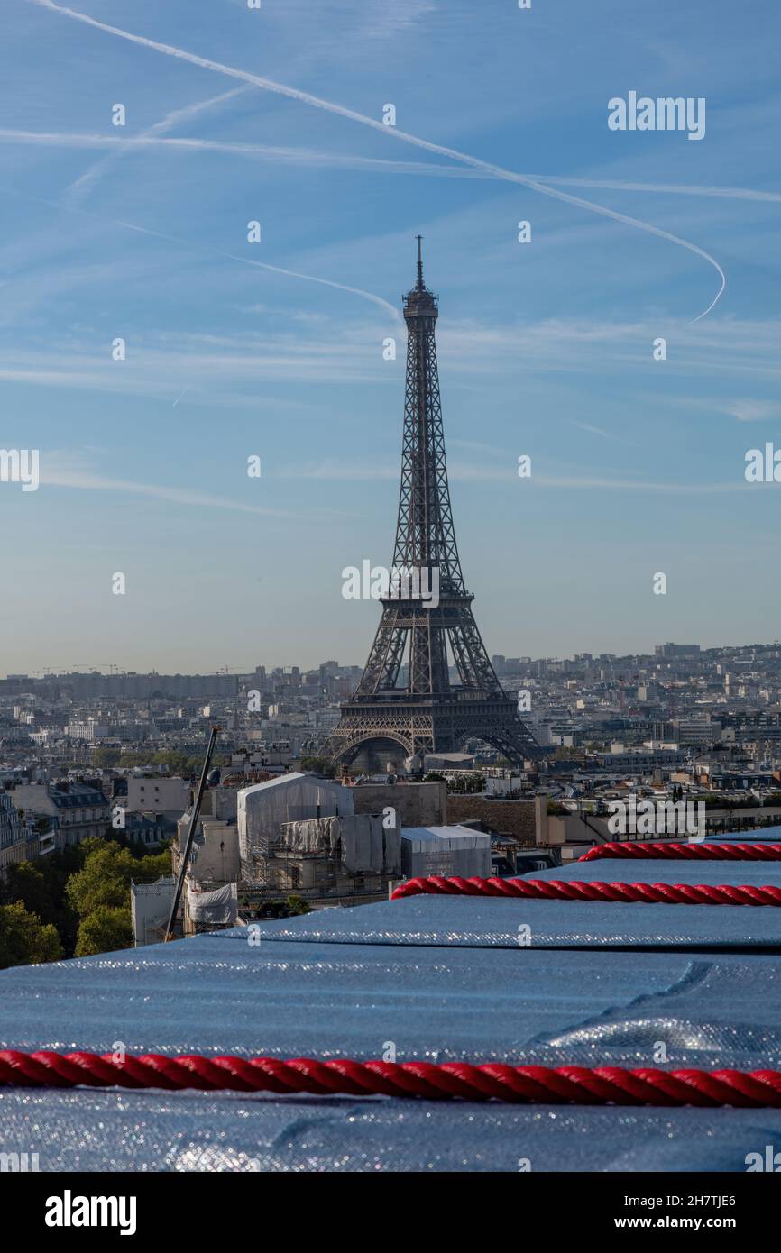 Paris, France-September 2021; High level view of Eiffel Tower seen from top of wrapped Arc de Triomphe art installation by Christo on Place Charles de Stock Photo
