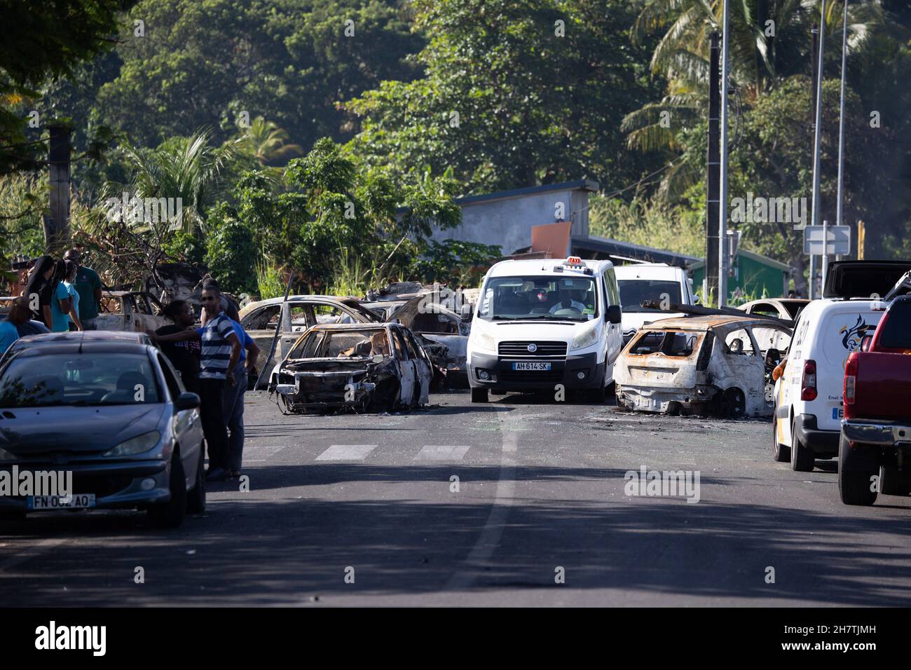 Taxi makes its way past barricades made of burnt cars at Montebello roundabout in Petit-Bourg, on the French Caribbean island of Guadeloupe on November 24, 2021 following days of rioting against Covid-19 measures. Photo by Raphael Lafargue/ABACAPRESS.COM Stock Photo