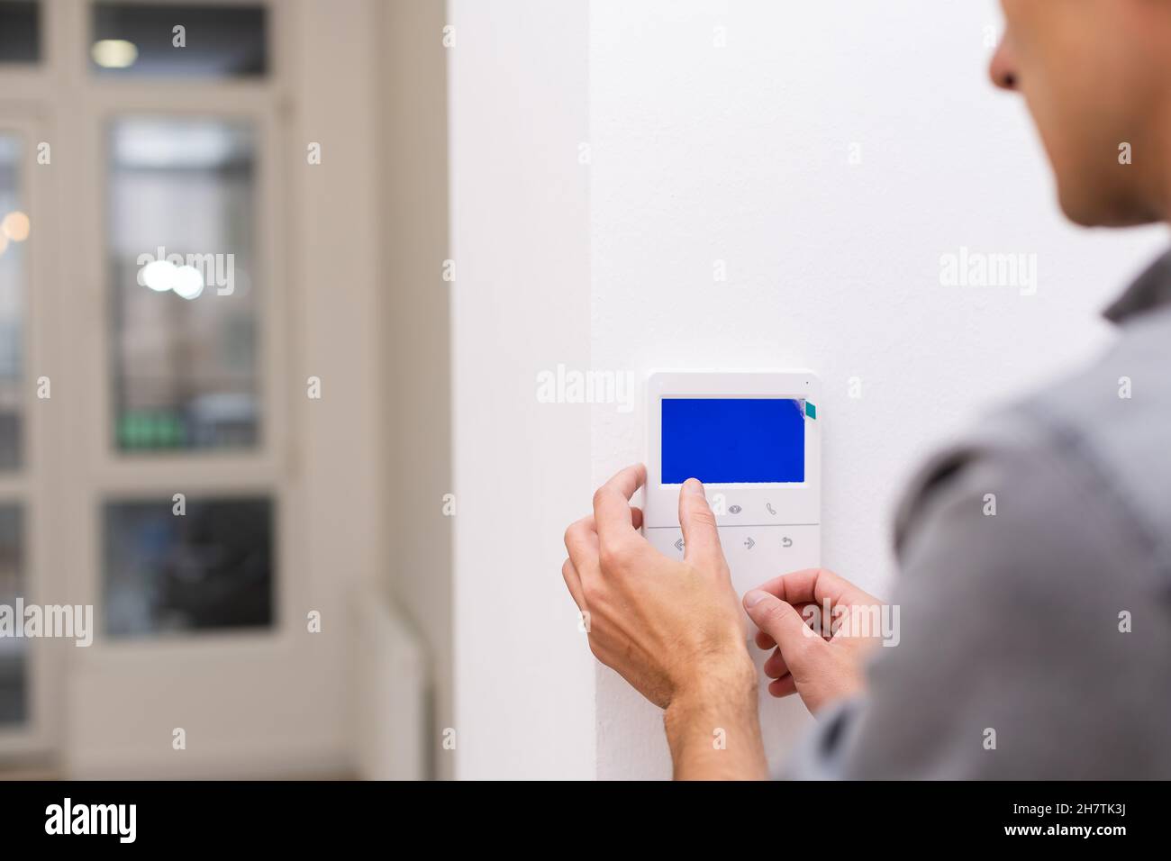 Man installing security alarm system on light wall at home, closeup Stock Photo Alamy