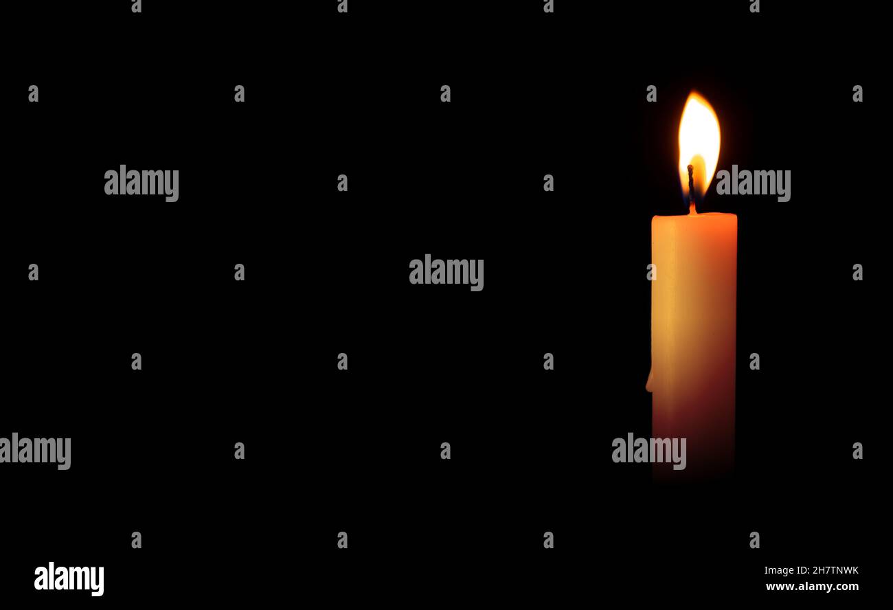 Burning candles on a black background. Blank space for inserting text ...