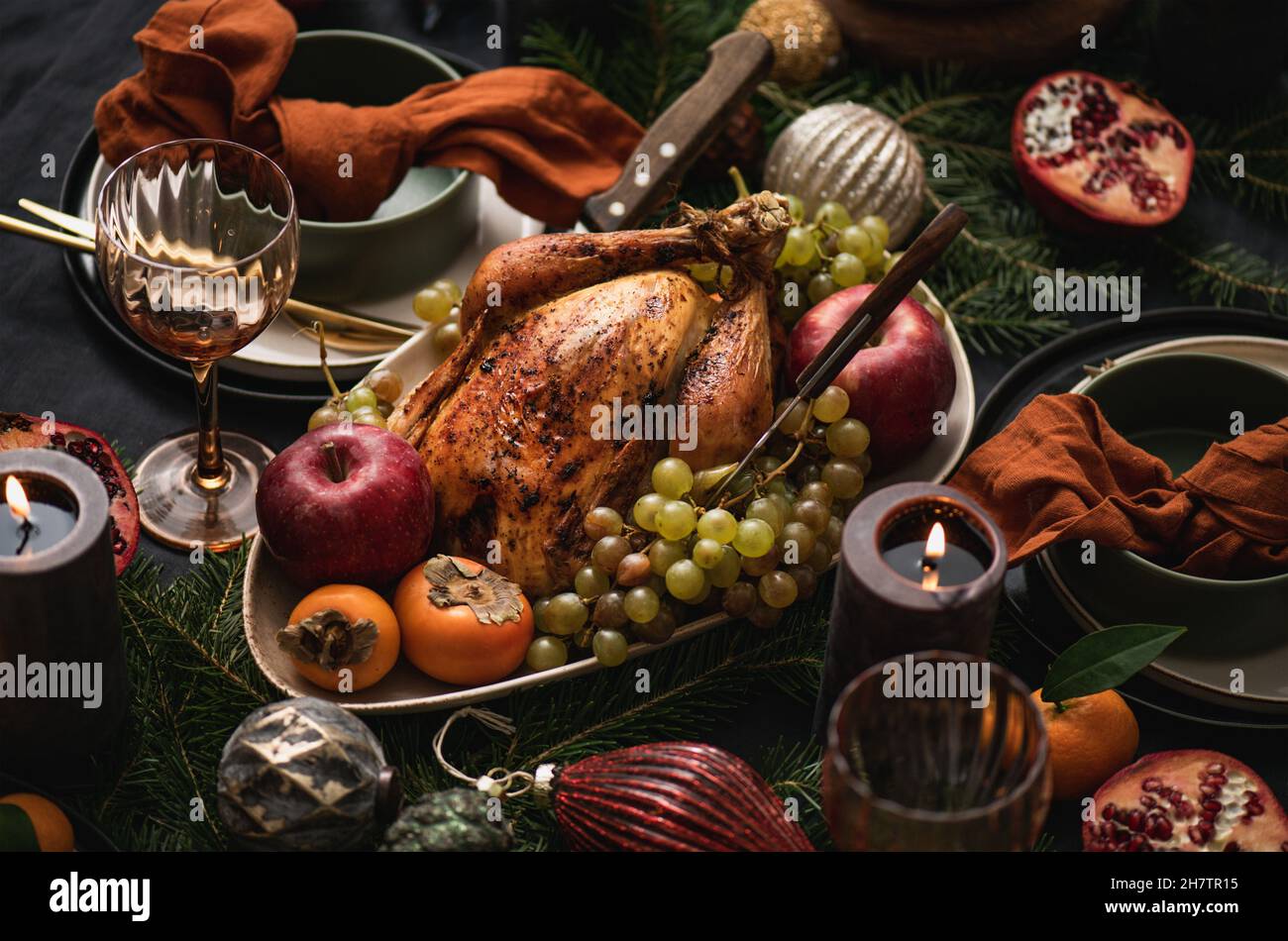 Festive dinner with whole roasted chicken and decorations Stock Photo