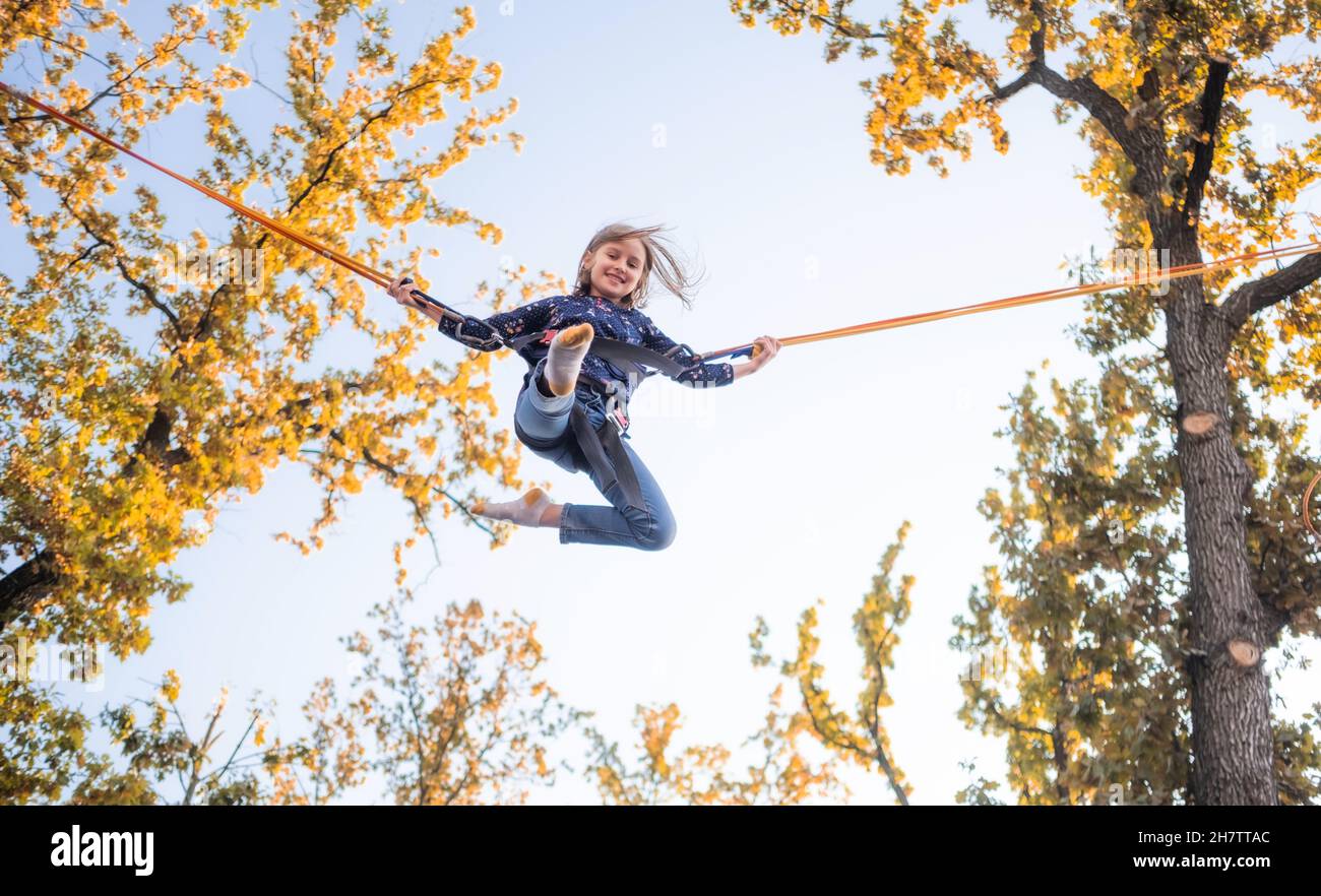 Little girl on trampoline jumping ropes Stock Photo Alamy